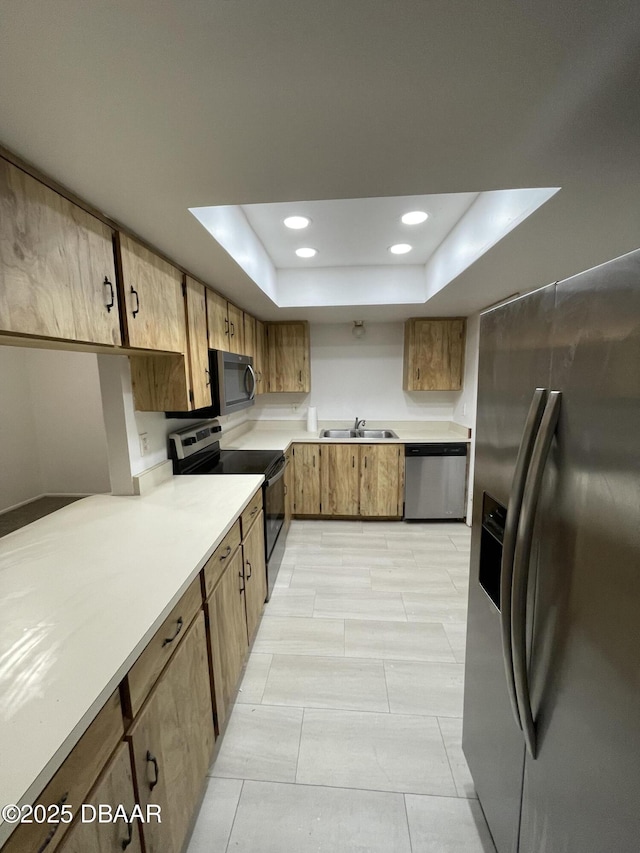 403 Banana Cay Dr Unit B, South Daytona, FL 32119 - kitchen with stainless steel appliances, light countertops, a raised ceiling, a sink, and recessed lighting