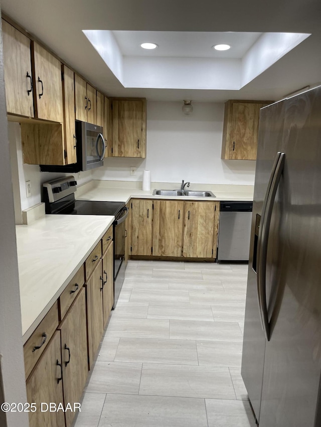 403 Banana Cay Dr Unit B, South Daytona, FL 32119 - kitchen with stainless steel appliances, a sink, a tray ceiling, light countertops, and recessed lighting