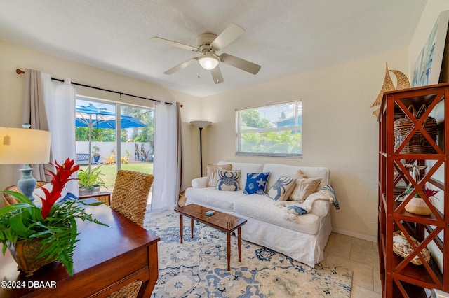 living room featuring ceiling fan and baseboards