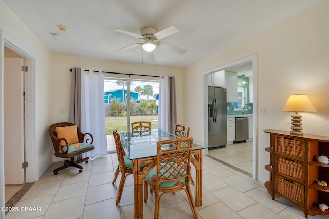 dining space with a ceiling fan and light tile patterned floors