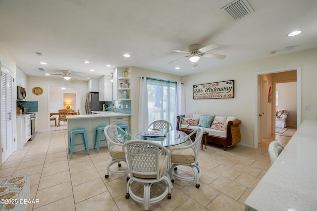 dining room with light tile patterned floors, baseboards, visible vents, a ceiling fan, and recessed lighting