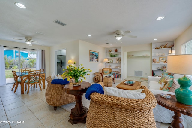 living room with built in features, recessed lighting, visible vents, and a ceiling fan