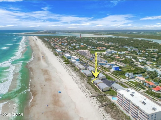 birds eye view of property featuring a water view and a beach view