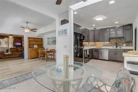 2144 Ridge Dr, Winter Park, FL 32792 - kitchen with dishwasher, ceiling fan, black fridge with ice dispenser, recessed lighting, and light countertops