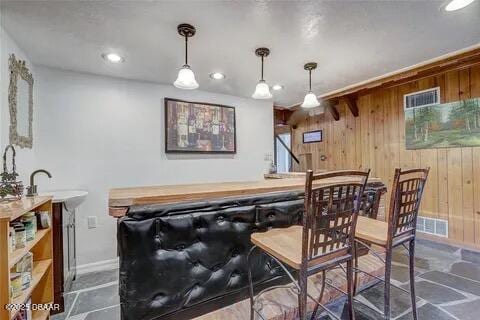 2144 Ridge Dr, Winter Park, FL 32792 - indoor dry bar with wood walls, hanging light fixtures, recessed lighting, and baseboards