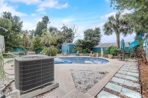 2144 Ridge Dr, Winter Park, FL 32792 - swimming pool with central AC, a storage unit, a patio, an outdoor structure, and fence