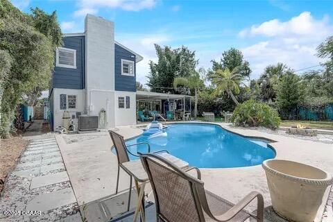 2144 Ridge Dr, Winter Park, FL 32792 - outdoor pool with a patio area and central AC unit