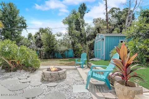 2144 Ridge Dr, Winter Park, FL 32792 - view of patio / terrace featuring an outdoor fire pit, a shed, and an outbuilding