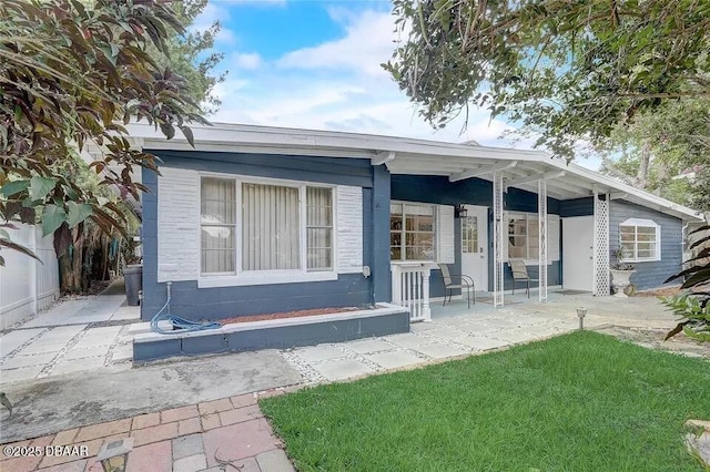 2144 Ridge Dr, Winter Park, FL 32792 - rear view of property with a porch and a lawn