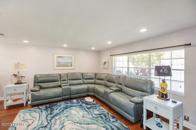 living room with baseboards, wood finished floors, and recessed lighting