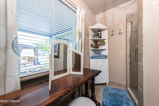 interior space with a shower with door