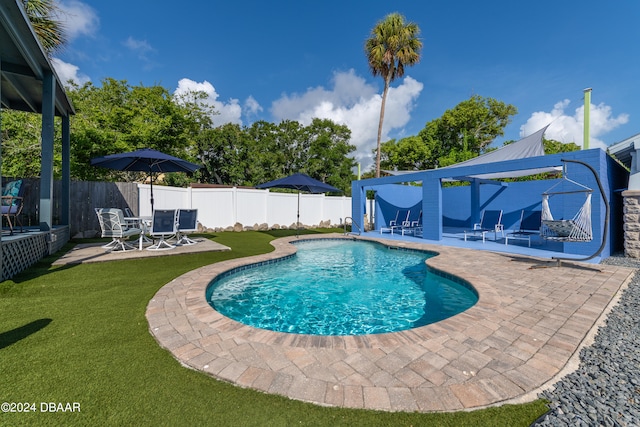 view of pool featuring a patio area and a lawn