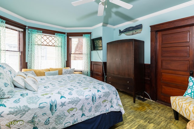 bedroom with ornamental molding, hardwood / wood-style floors, and ceiling fan