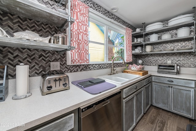 kitchen with stainless steel dishwasher, dark hardwood / wood-style floors, sink, and decorative backsplash