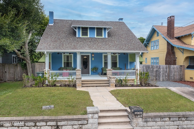 view of front facade with a front yard and covered porch