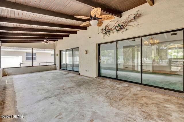 interior space featuring ceiling fan, beam ceiling, and concrete floors