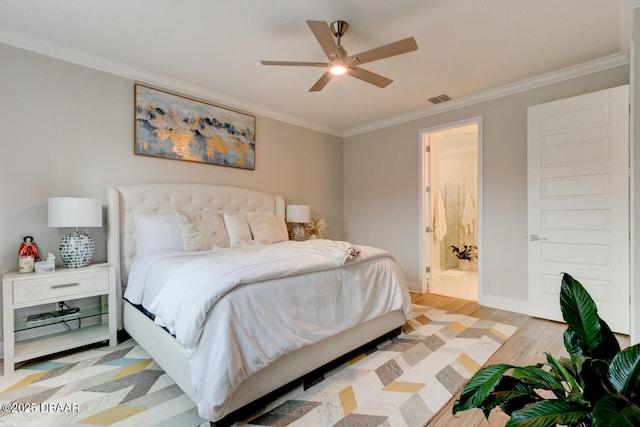 bedroom featuring baseboards, light wood-style flooring, visible vents, and crown molding