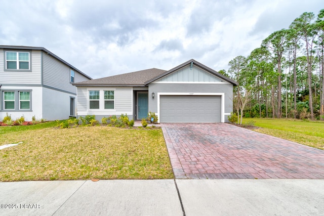 view of front of house with decorative driveway, a shingled roof, an attached garage, board and batten siding, and a front yard