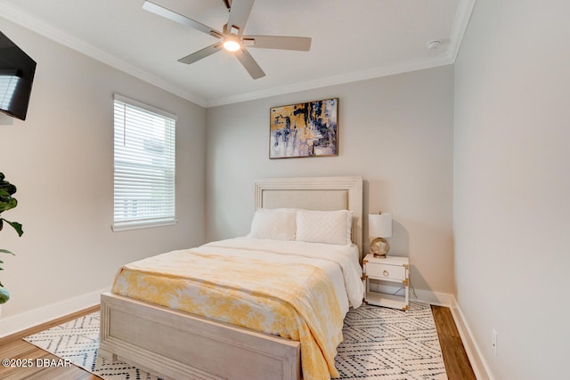 bedroom featuring ornamental molding, light wood-style flooring, and baseboards