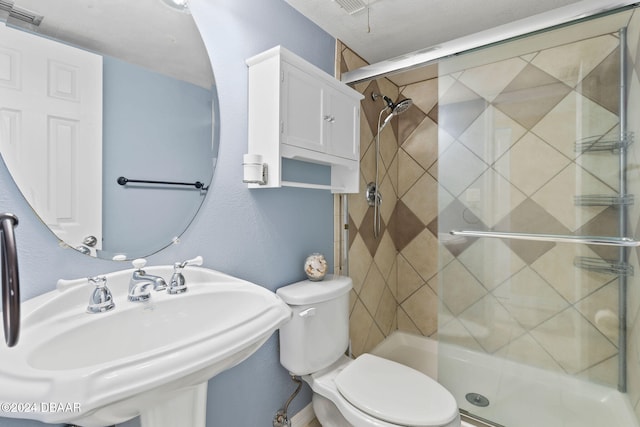 bathroom featuring toilet, an enclosed shower, and sink