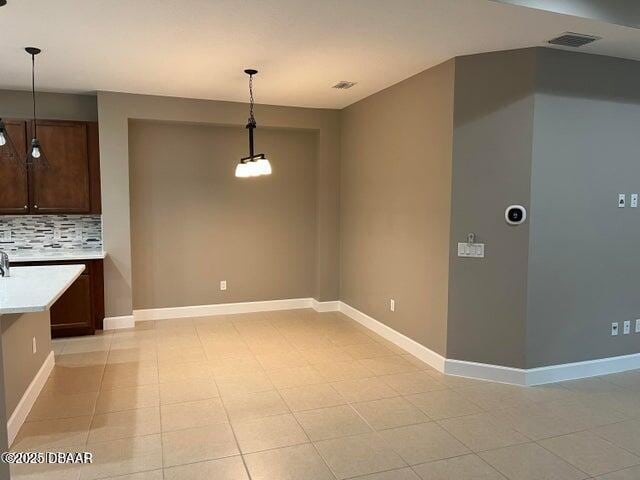 unfurnished dining area featuring visible vents and baseboards