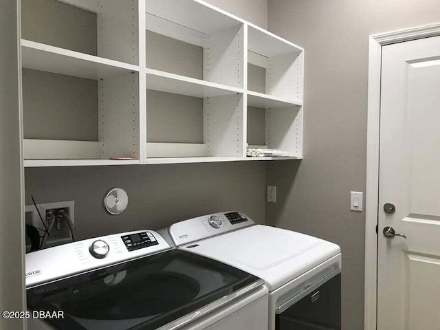 clothes washing area featuring washer and clothes dryer