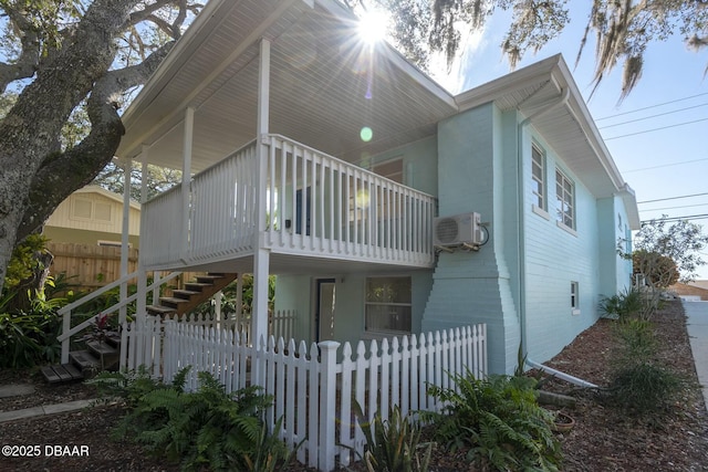 view of home's exterior with a porch and ac unit