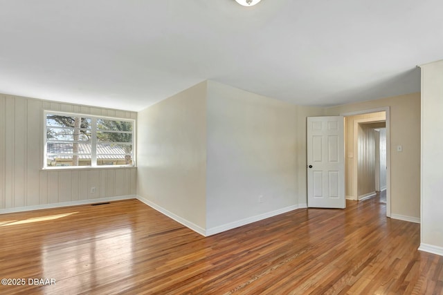 unfurnished room with wood-type flooring