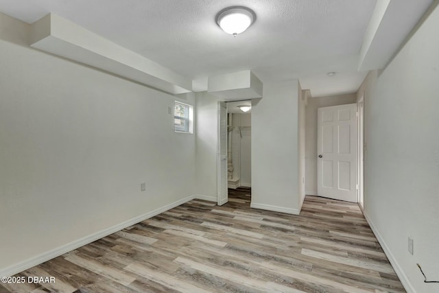 interior space featuring light hardwood / wood-style flooring and a textured ceiling