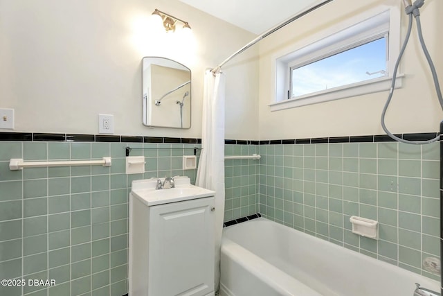 bathroom featuring vanity, tile walls, and shower / tub combo with curtain