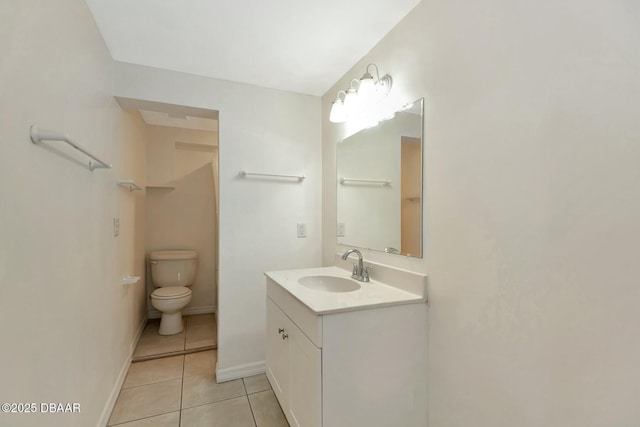 bathroom featuring vanity, tile patterned floors, and toilet