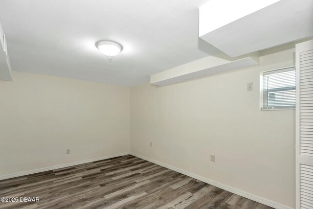 basement featuring dark hardwood / wood-style flooring