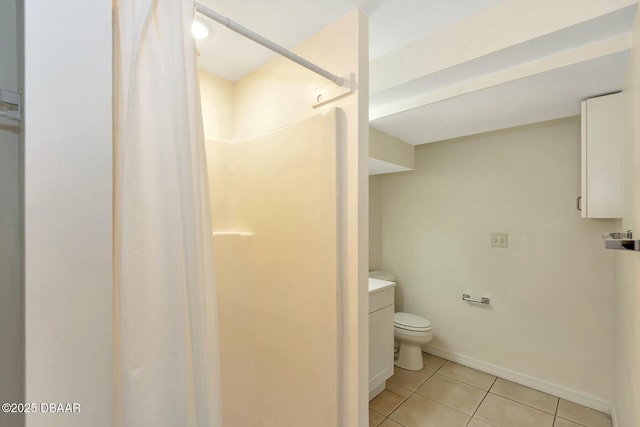 bathroom with vanity, tile patterned floors, toilet, and walk in shower