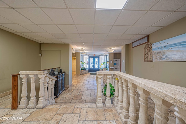 hallway with a drop ceiling