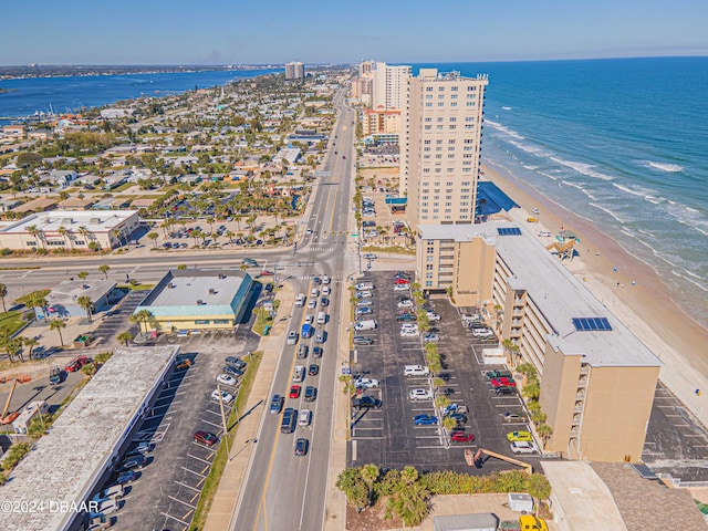 drone / aerial view featuring a water view and a view of the beach