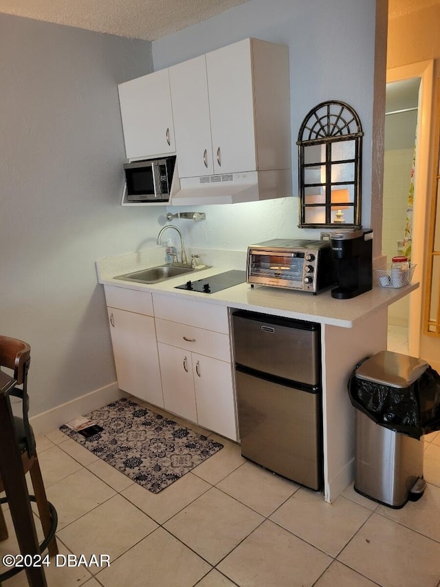 kitchen with white cabinetry, sink, a textured ceiling, and appliances with stainless steel finishes