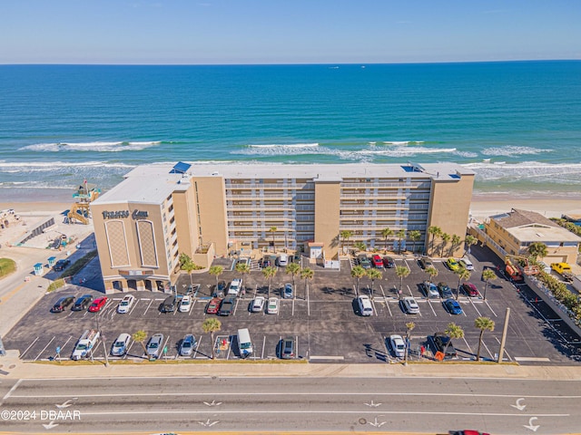 drone / aerial view with a water view and a view of the beach