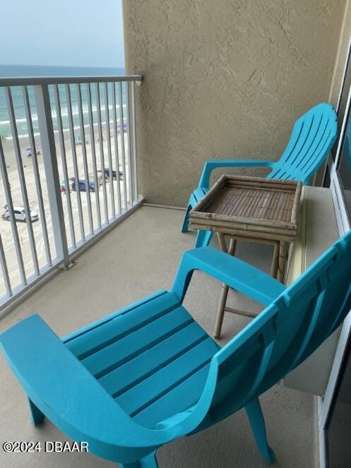 balcony with a beach view and a water view