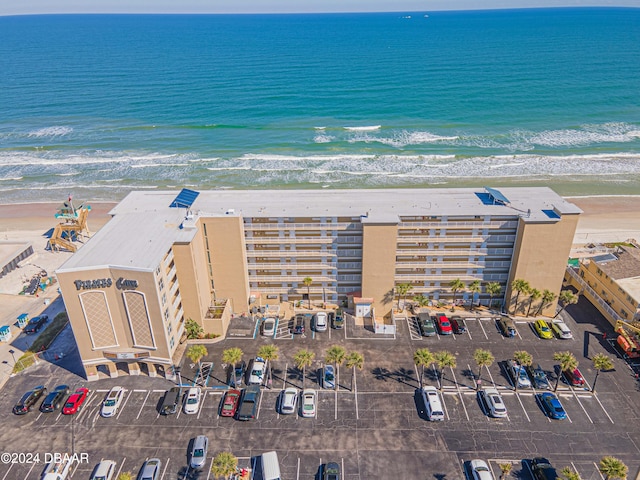 drone / aerial view featuring a view of the beach and a water view