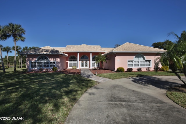 view of front of house with a front lawn and french doors