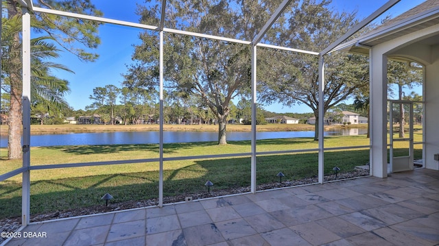 unfurnished sunroom featuring a water view