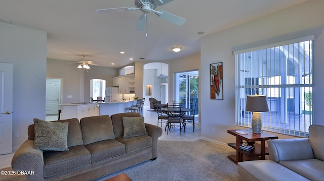 living room with light carpet and ceiling fan