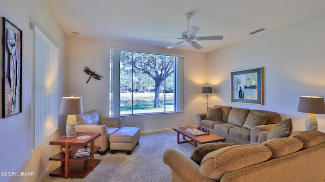 carpeted living room with ceiling fan and a healthy amount of sunlight