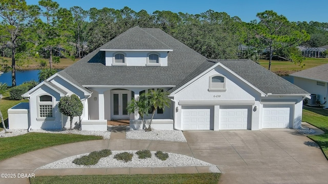 view of front facade with central AC, french doors, and a garage