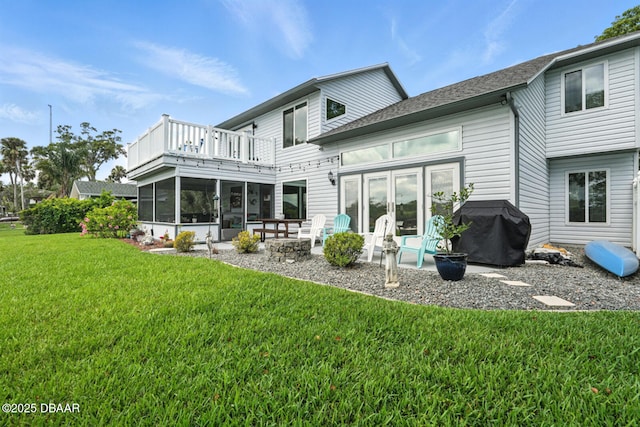 453 Palm Ave, Ormond Beach, FL 32174 - rear view of house with a balcony, a lawn, a sunroom, french doors, and a patio area