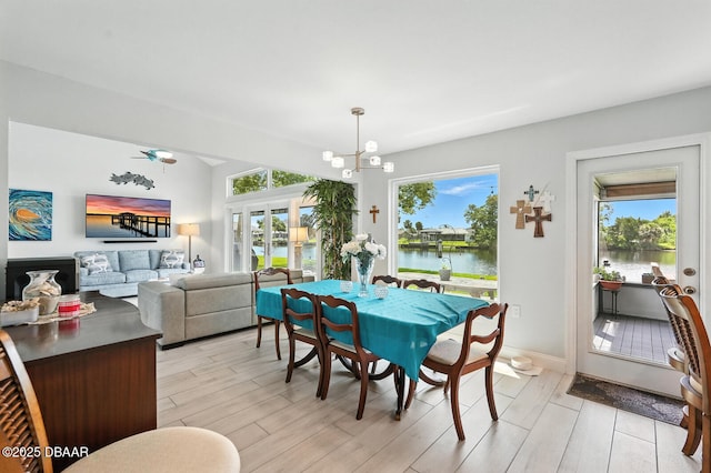 453 Palm Ave, Ormond Beach, FL 32174 - dining space featuring a chandelier, light wood-style floors, and a water view
