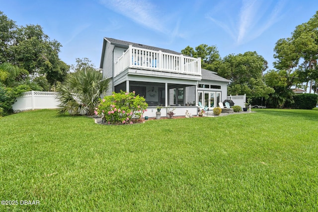 453 Palm Ave, Ormond Beach, FL 32174 - back of property with a sunroom, a fenced backyard, and roof with shingles