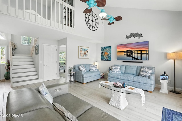 453 Palm Ave, Ormond Beach, FL 32174 - living area featuring a ceiling fan, stairs, wood finished floors, and a high ceiling