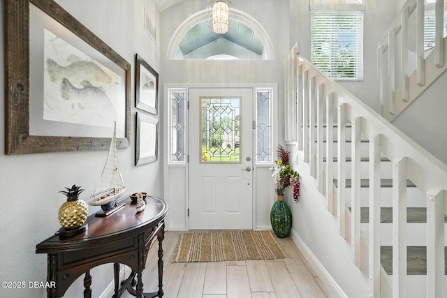 453 Palm Ave, Ormond Beach, FL 32174 - foyer entrance featuring a chandelier, stairway, and wood finished floors