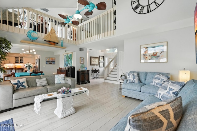 453 Palm Ave, Ormond Beach, FL 32174 - living area with a high ceiling, ceiling fan, wood finished floors, and stairs